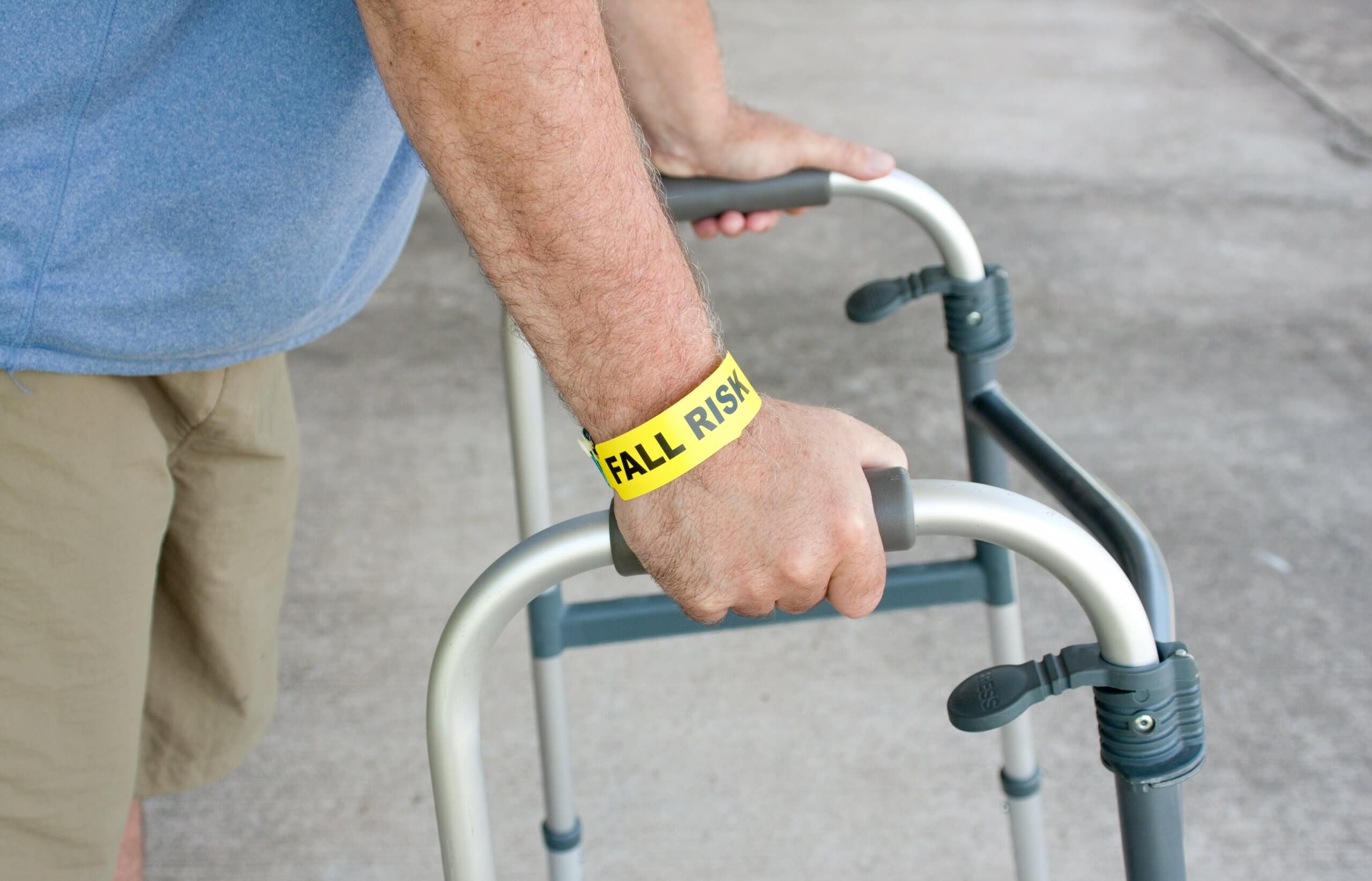An,Elderly,Man,Wearing,A,Fall,Risk,Bracelet,Around,His